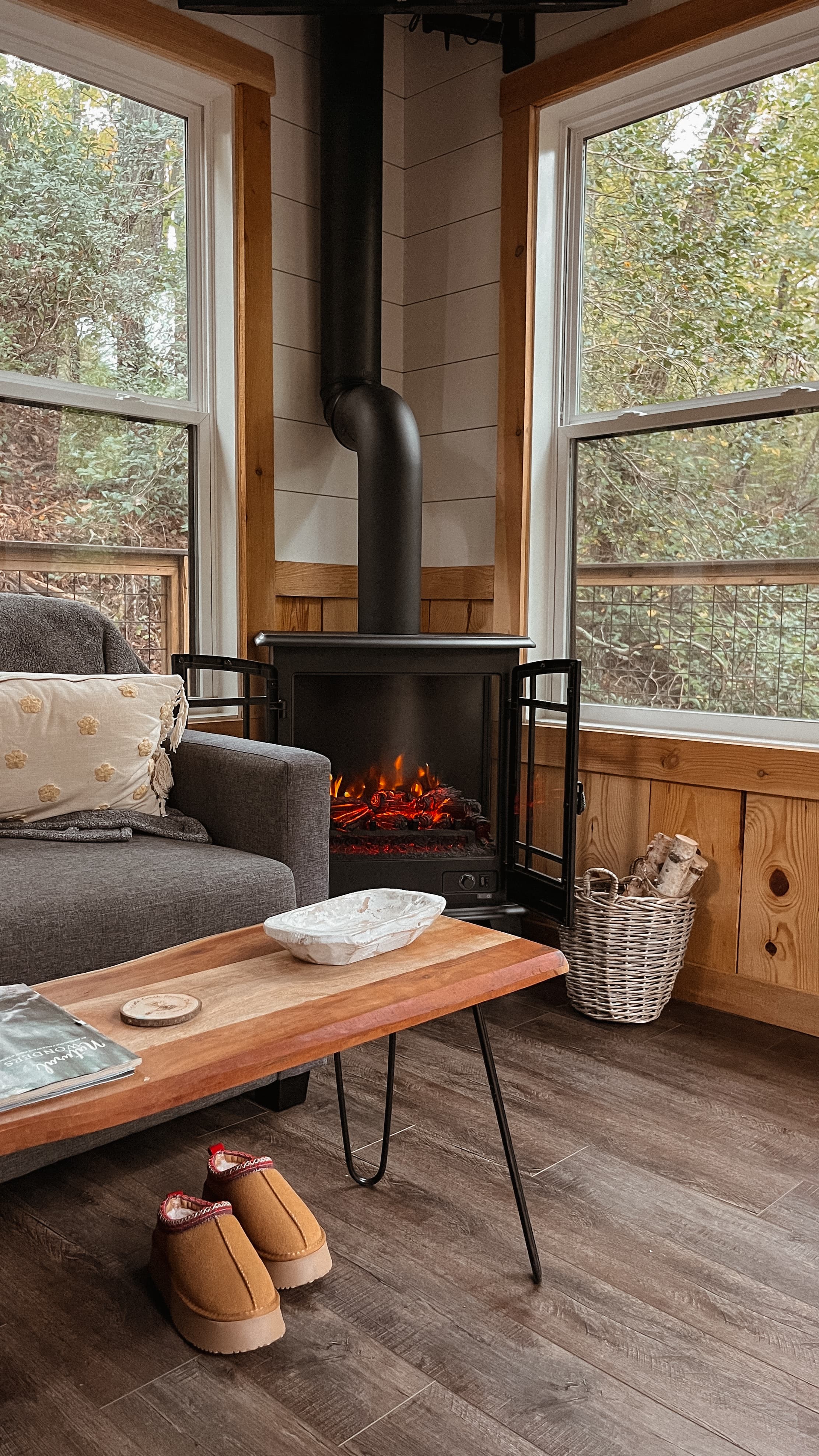 Cozy West Michigan cabin Airbnb interior with wood stove and forest views